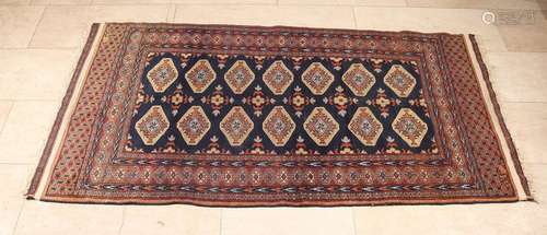 Old Persian rug in blue / black / brown. Floral decor.