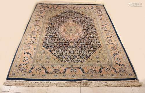 Hand-knotted Persian rug. Light color, blue border and