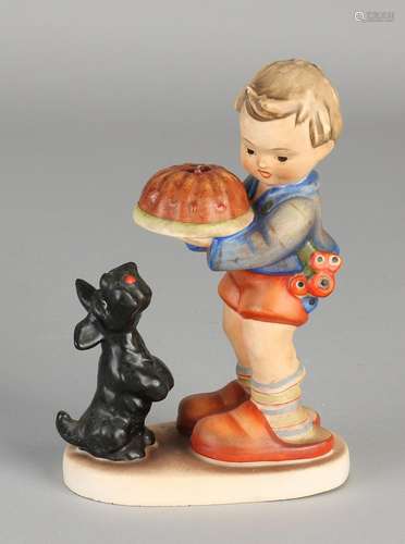 Old German ceramics Hummel figure. Boy with cake and