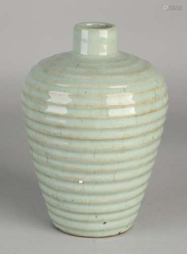 Chinese porcelain vase with ripples and celadon glaze.