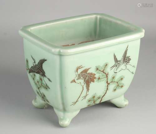 Antique Japanese green porcelain pot with crane decor.