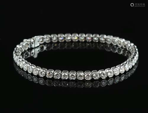 Diamond line bracelet; forty-six round cut diamonds in a rubover, hexagonal settings, estimated