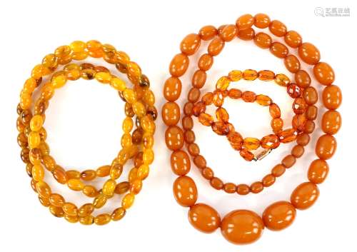 Three bead necklaces, one long necklace, testing as an Amber and resin composite, with oval beads