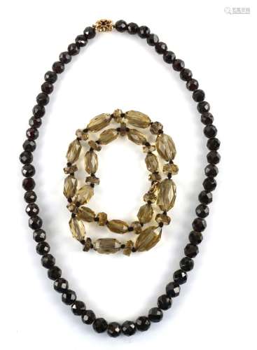Necklace of faceted garnet beads to a gold clasp, stamped 9 ct, length 48 cm, and another of