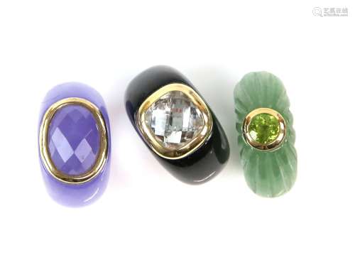 Three gemstone rings, one set with a round cut peridot, another amethyst and a checkerboard cut