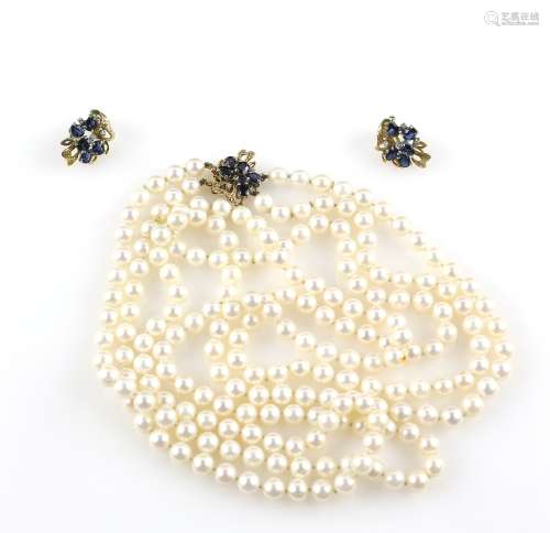 Double string of cultured pearls secured to a sapphire and diamond set gold clasp, pearls of uniform