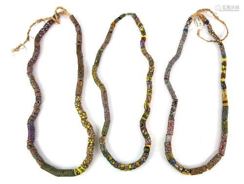 Three African trade bead necklaces, rolled millefiore glass in venetian style 19th century and