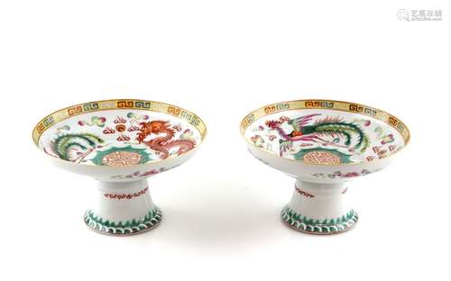 A pair of famille rose stem dishes; each one decorated on the top with a dragon and a phoenix (