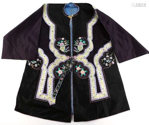 A Chinese or other Asian textile tunic with blue silk interior lining; decorated with floral bands