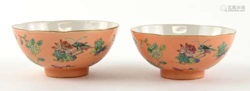 A pair of coral ground, famille rose bowls, each one decorated with insects and floral designs, 9.