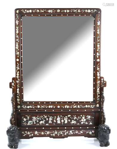 A Vietnamese, or other Asian, wood mounted mirror; the stand designed with recumbent Buddhistic