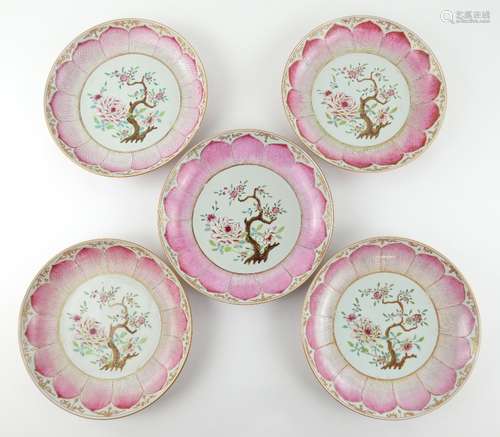 A set of five famille rose dishes; each one decorated with a central floral design surrounded by a