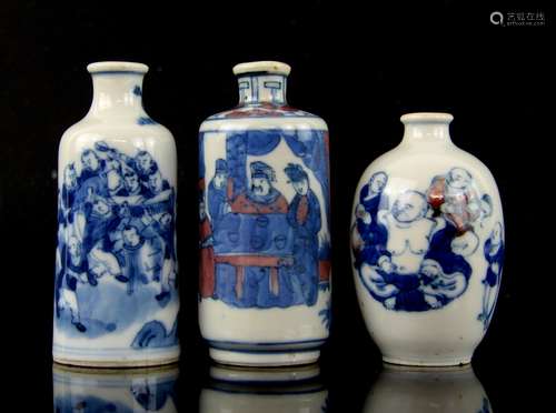 Three Chinese snuff bottles: one in blue and white decorated with a group of boys beside a tree,