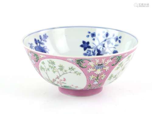 A pink ground, famille rose medallion bowl; the underglaze blue decorated interior depicting a