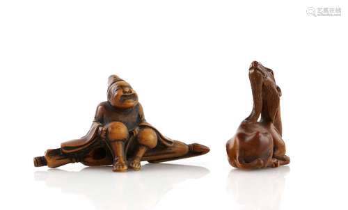 Two wood netsuke, comprising: a seated traveller wearing waraji, 7 cm long; and a seated kirin