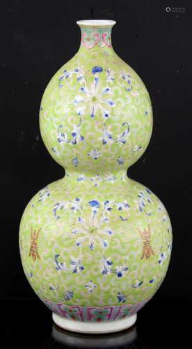 A lime-green ground double gourd vase with scrolling and floral designs; the base with Tongzhi six-