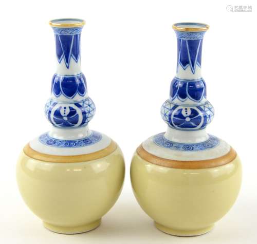 A pair of underglaze blue and pale monochrome decorated vases, each one about 16 cm high, post