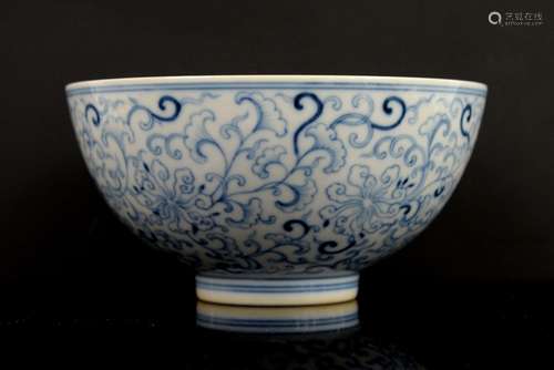 A blue and white bowl, decorated on the exterior with formal floral designs, the base with