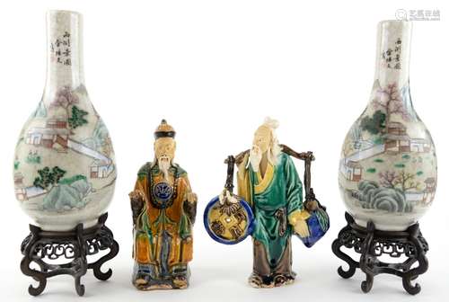 A pair of famille rose vases; each one decorated with a group of scholars in a mountainous