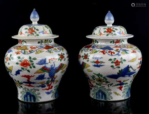 A pair of wucai style oviform vases; each one with a domed cover and knop finial; both decorated