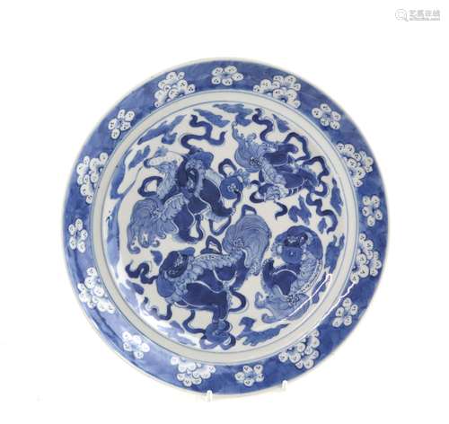 A Chinese blue and white dish of circular form, decorated with a bold design of four Buddhistic