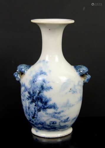 A small blue and white vase with trumpet neck and animal head handles, decorated with a solitary