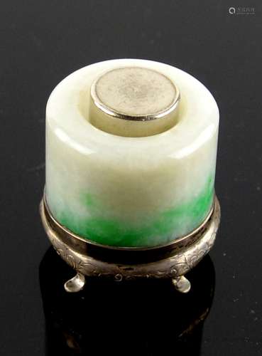 A mottled jadeite, or other stone, archer's ring mounted in white metal as a gentleman's