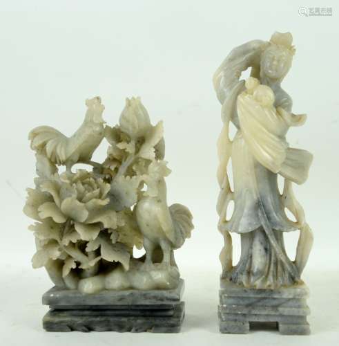 Two Chinese soapstone sculpture: one carved as a standing girl holding a rabbit and wearing a