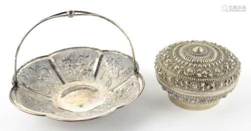 A Chinese white metal dish of foliate form, decorated with trapezoid panels variously depicting