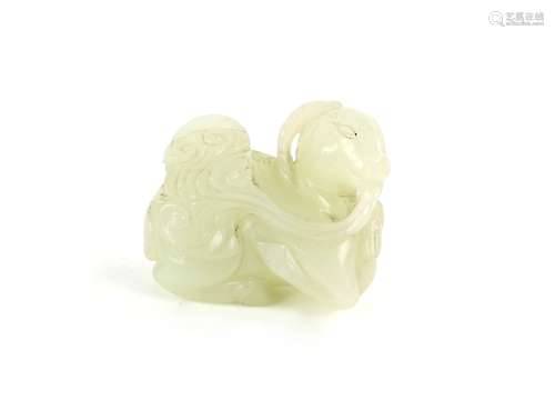 A small green jade, carved as a seated goat, holding a fungus [or other object] beside its young;