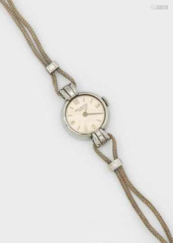 Patek Philippe Damenarmbanduhr von 1945Stahl. Rundes Uhrengehäuse mit konisch ansteigenden Anstößen,