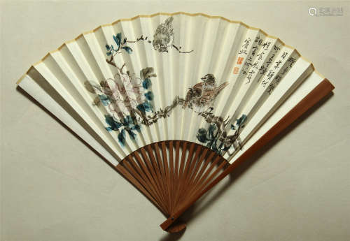 A CHINESE SCROLL PAINTING FAN OF BIRD ON FLOWER WITH CALLIGRAPHY BY HUANG BINHONG