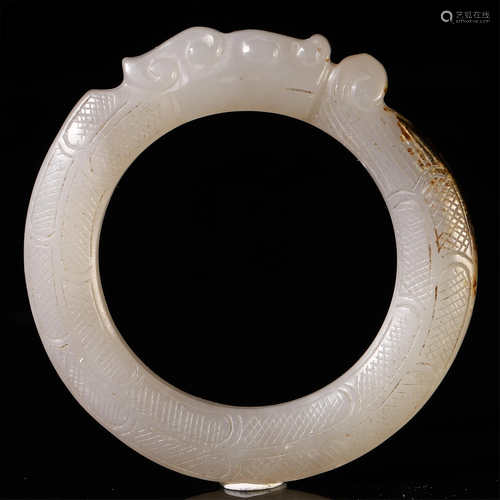 A CHINESE WHITE JADE CARVED BANGLE