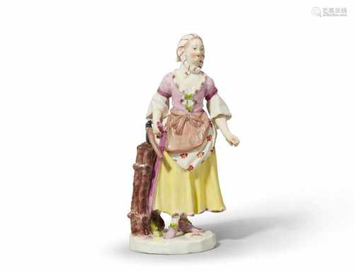 A Vienna porcelain figure of a girl carrying woodFinely painted figure of a girl in an apron