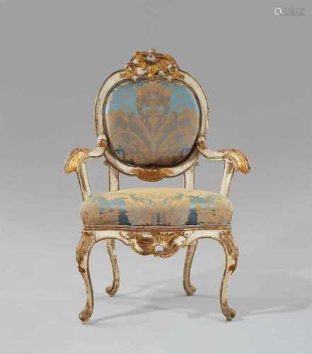 A Potsdam softwood armchairCarved softwood painted in silver and gold, replaced silk upholstery.