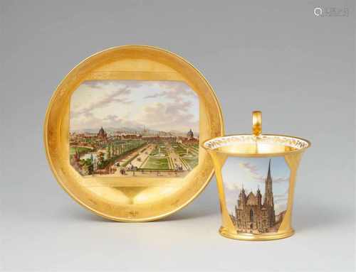 A Vienna porcelain cup and saucer with views of ViennaBell-shaped cup with tall scroll handle,