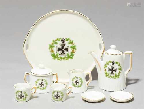 A porcelain dolls' house coffee set with the iron crossComprising a round tray, coffeepot and