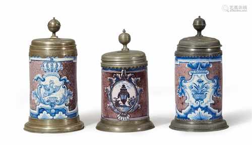 Three Berlin faience tankards1. Cartouche with an eagle and the device SUUM CUIQUE, lid inscribed