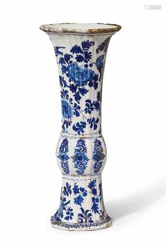 A rare Berlin faience trumpet vase with lacquer decorGu-form vase decorated with peacocks, rocks,