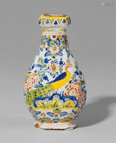 A small Berlin faience vase with peacock decorBaluster-form flask of octagonal section with a