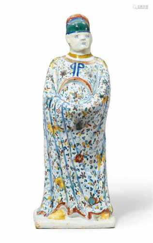 A rare Berlin faience figure of a Chinese officialThe robes decorated with flowerhead and clover