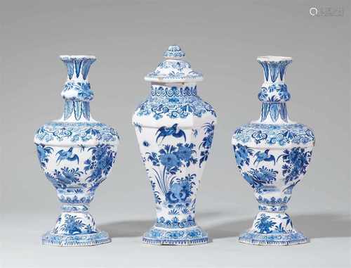 A rare set of Berlin faience vases with bird-on-rock motifsComprising a vase and cover and a pair of