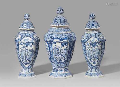 A rare set of three Berlin faience vases and coversBaluster-form vase of octagonal section, original