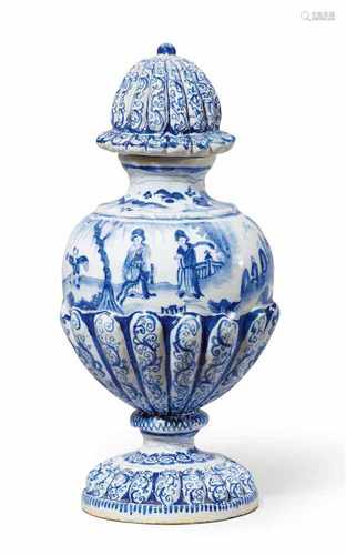 A Berlin faience vase and cover with Chinoiserie decorBaluster-form vase with gadrooned base,