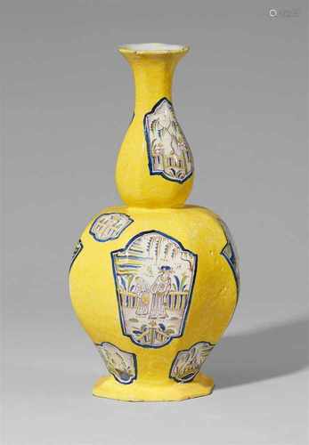 A yellow gourd-form faience vase with chinoiserie decorOctagonal facetted vases decorated with