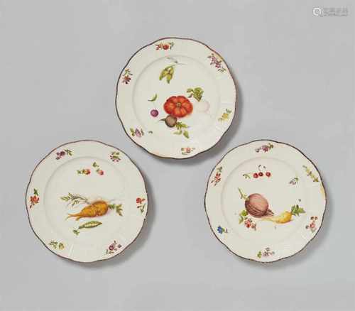 Three Vienna porcelain plates with fruit and vegetable decorWith ozier mouldings and scattered