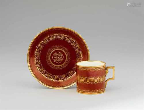 A Vienna porcelain cup and saucer with gilt tendrilsOf cylindrical form with original saucer.