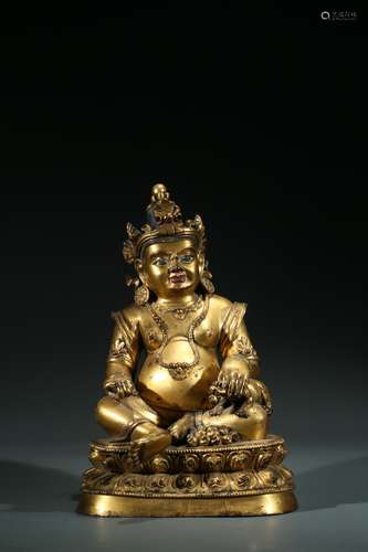 A TIBETAN GILT BRONZE FIGURE OF JAMBHALA