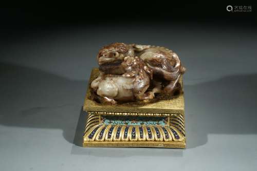 A CELADON JADE BUDDHIST LION AND CUB WITH STAND