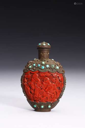 A CARVED CINNABAR LACQUER BRONZE SNUFF BOTTLE